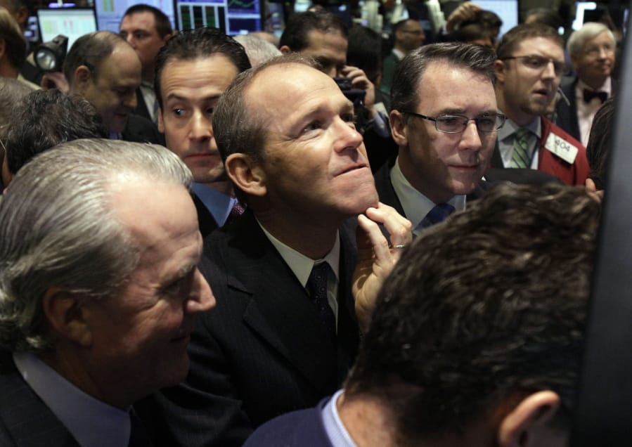 Then-Nielsen Company CEO David Calhoun, center, watches progress as he waits for the company&#039;s IPO to begin trading, on the floor of the New York Stock Exchange. Calhoun, Boeing&#039;s new CEO, said Wednesday that production of the 737 Max will resume this spring, months before the company expects federal regulators to certify the grounded plane to fly again.