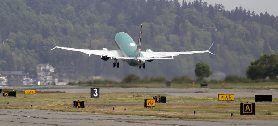 FILE - In this May 8, 2019, file photo a Boeing 737 MAX 8, being built for American Airlines, is partially obscured by the engine wash as it takes-off on a test flight in Renton, Wash. A government committee reviewing how the Federal Aviation Administration certifies new passenger planes for flight has determined that the system is safe and effective but small changes need to be made. The committee was appointed by Transportation Secretary Elaine Chao in April after two deadly crashes involving Boeing&#039;s 737 Max.