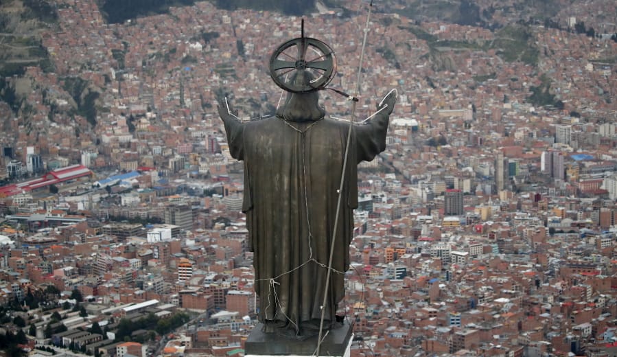 A Christ statue overlooks El Alto, a city adjoining the capital city La Paz, Bolivia. Ancestral indigenous practices became more visible during the presidency of Evo Morales, who recognized the Andean earth deity Pachamama.