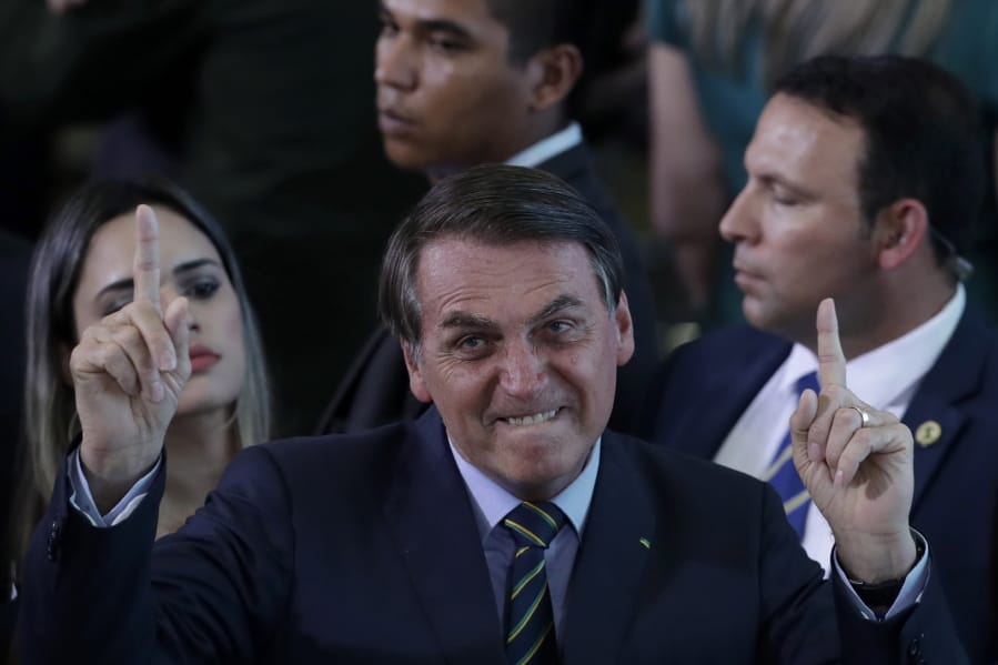 Brazil&#039;s President Jair Bolsonaro gestures during an event with young Venezuelan migrants at the Planalto Presidential Palace in Brasilia, Brazil, Thursday, Jan. 16, 2020. According to the UNHCR there are around 180,000 Venezuelan refugees and migrants in the country, many of them arrived crossing the border  in the northern state of Roraima.