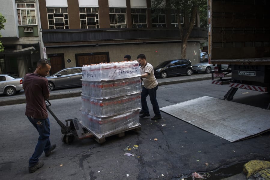 Workers move bottled water to be sold at a supermarket in the Copacabana neighborhood of Rio de Janeiro, Brazil, Wednesday, Jan. 15, 2020. There&#039;s a creeping sense of alarm in Rio de Janeiro after more than a week of foul tasting and smelling tap water in dozens of neighborhoods, and residents are hoarding bottled water.
