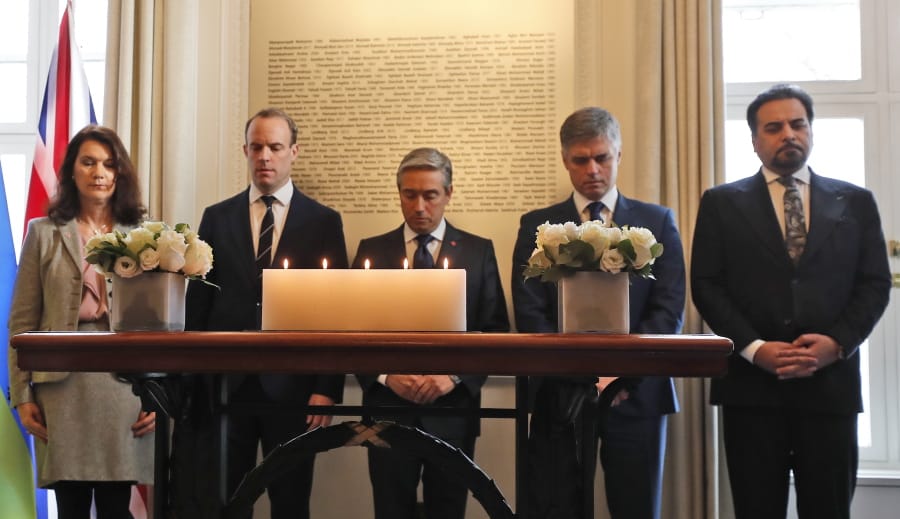 Francois-Philippe Champagne, Canada Minister of Foreign Affairs, centre, Ukraine Minister of Foreign Affairs Vadym Prystaiko, second right, United Kingdoms Secretary of State for Foreign Affairs Dominic Raab, second left, Sweden&#039;s Minister of Foreign Affairs Ann Linde, left, and Afghanistan&#039;s Foreign Minister Idrees Zaman, hold a minute of silence behind candles and in front of a plaque with the names of the victims of flight PS752, at the High Commission of Canada in London, Thursday, Jan. 16, 2020. The Foreign ministers gather in a meeting of the International Coordination and Response Group for the families of the victims of PS752 flight crashed shortly after taking off from the Iranian capital Tehran on Jan.