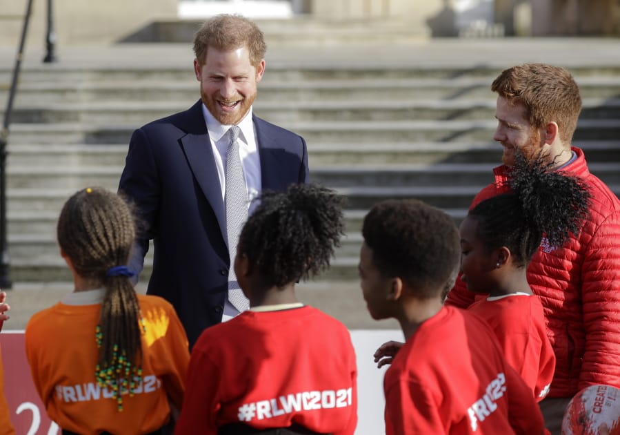Britain&#039;s Prince Harry smiles at schoolchildren in the gardens at Buckingham Palace in London, Thursday, Jan. 16, 2020. Prince Harry, the Duke of Sussex will host the Rugby League World Cup 2021 draw at Buckingham Palace, prior to the draw, The Duke met with representatives from all 21 nations taking part in the tournament, as well as watching children from a local school play rugby league in the Buckingham Palace gardens.