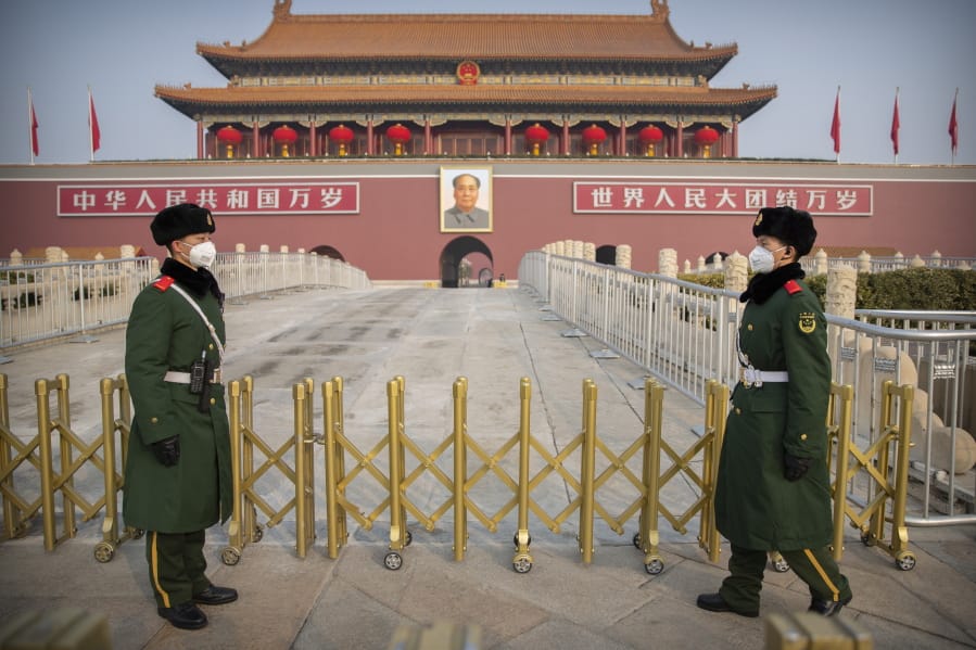 Paramilitary police wear face masks as they stand guard at Tiananmen Gate adjacent to Tiananmen Square in Beijing, Monday, Jan. 27, 2020. China on Monday expanded sweeping efforts to contain a viral disease by postponing the end of this week&#039;s Lunar New Year holiday to keep the public at home and avoid spreading infection.