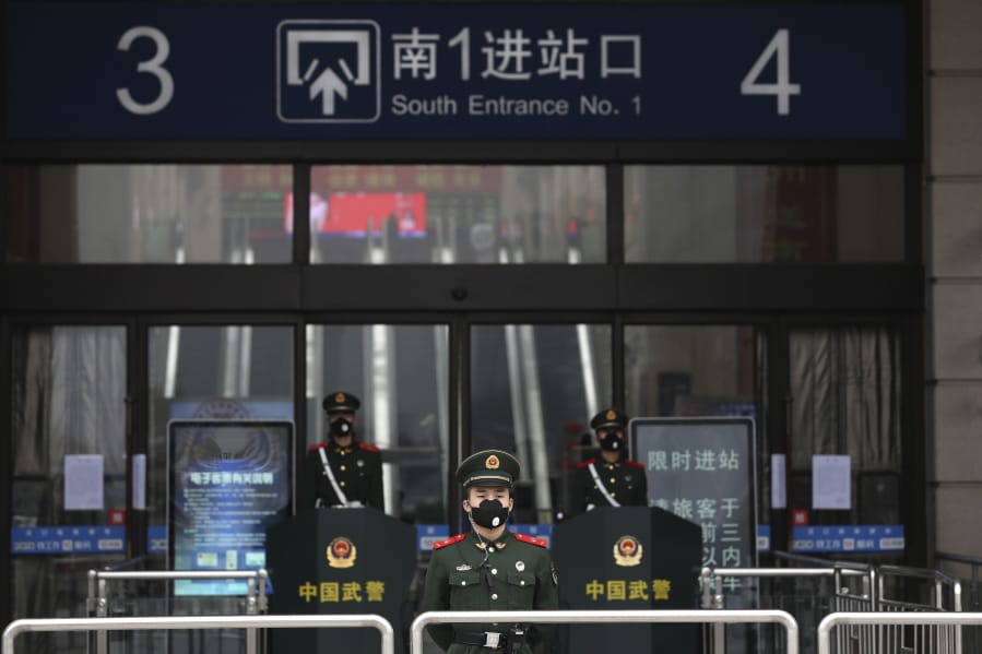 FILE - In this Jan. 23, 2020, file photo, Chinese paramilitary police stand guard outside the closed Hankou Railway Station in Wuhan in central China&#039;s Hubei Province. Cutting off access to entire cities with millions of residents to stop a new virus outbreak is a step few countries other than China would consider, but it is made possible by the ruling Communist Party&#039;s extensive social controls and experience fighting the 2002-03 outbreak of SARS.