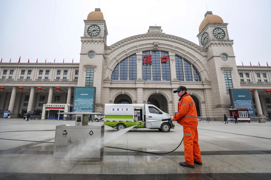 A worker hoses down garbage bins outside the closed Hankou Railway Station in Wuhan in central China&#039;s Hubei Province, Thursday, Jan. 23, 2020. Overnight, Wuhan authorities announced that the airport and train stations would be closed, and all public transportation suspended by 10 a.m. Friday. Unless they had a special reason, the government said, residents should not leave Wuhan, the sprawling central Chinese city of 11 million that&#039;s the epicenter of an epidemic that has infected nearly 600 people.