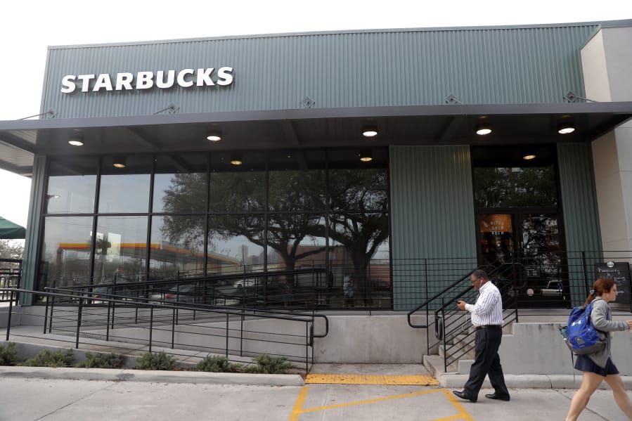 FILE - In this Jan. 16, 2020, file photo customers come and go at a Starbucks on South Claiborne Ave. in New Orleans.
