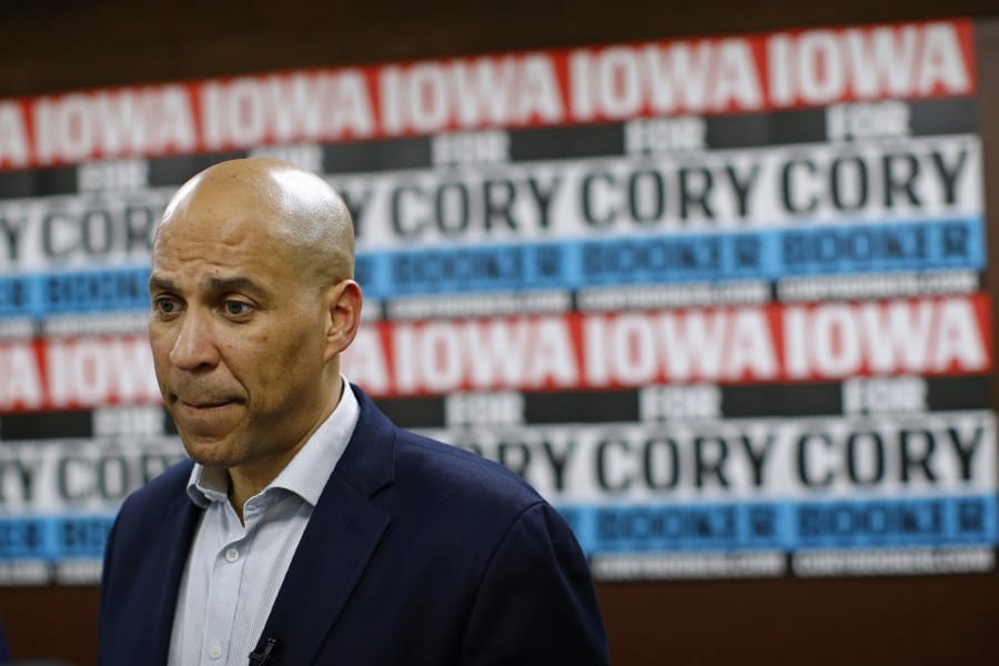 FILE - In this Jan. 9, 2020 file photo, Democratic presidential candidate Sen. Cory Booker, D-N.J., speaks with attendees after a campaign event in Mount Vernon, Iowa. Booker has dropped out of the presidential race after failing to qualify for the December primary debate.