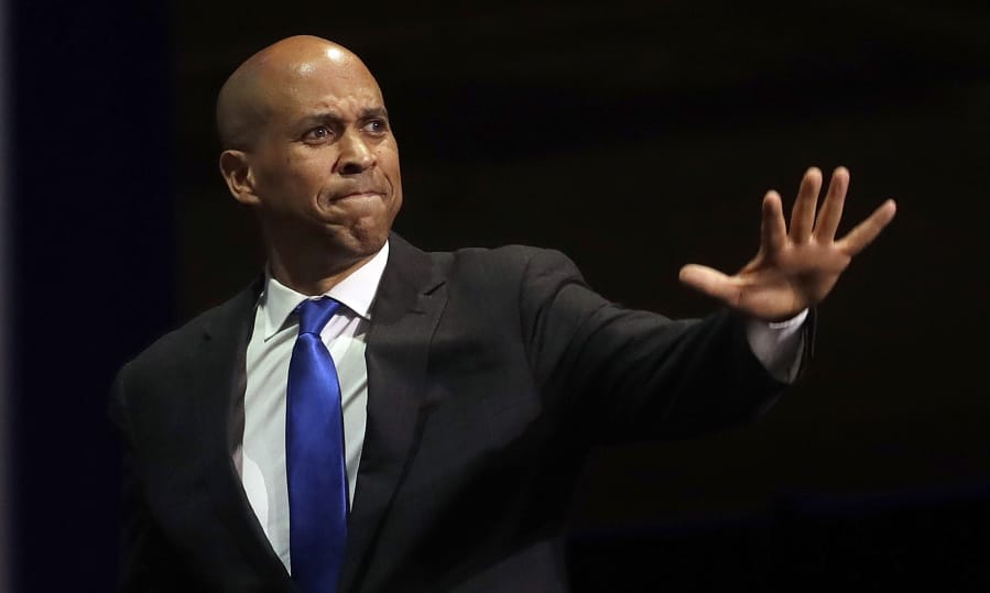 FILE - In this June 1, 2019 file photo, Democratic presidential candidate Sen. Cory Booker, of New Jersey, waves before speaking during the 2019 California Democratic Party State Organizing Convention in San Francisco.  Booker has dropped out of the presidential race after failing to qualify for the December primary debate.