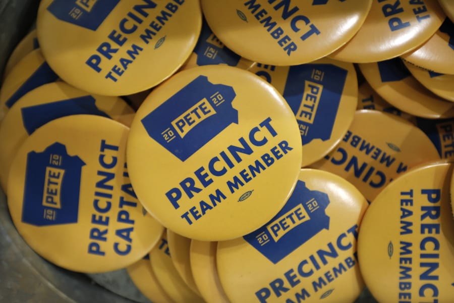 FILE - In this Jan. 9, 2020, file photo, precinct team member buttons are seen during a caucus training meeting at the local headquarters for Democratic presidential candidate former South Bend, Ind., Mayor Pete Buttigieg, in Ottumwa, Iowa.