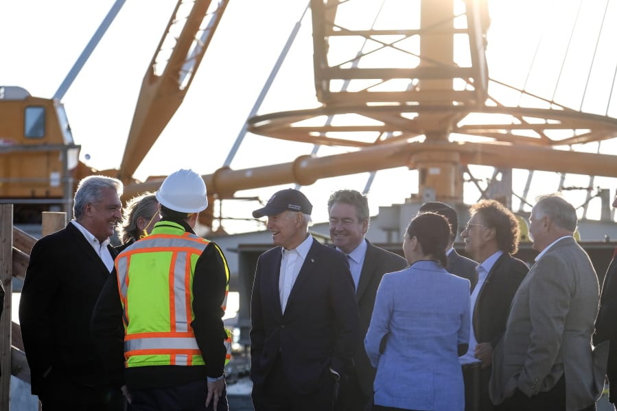 Former Vice President Joe Biden, center, talks with  officers of Ports of Long Beach during a tour of the Gerald Desmond Bridge Replacement Project Thursday in Long Beach, Calif. (ringo h.w.