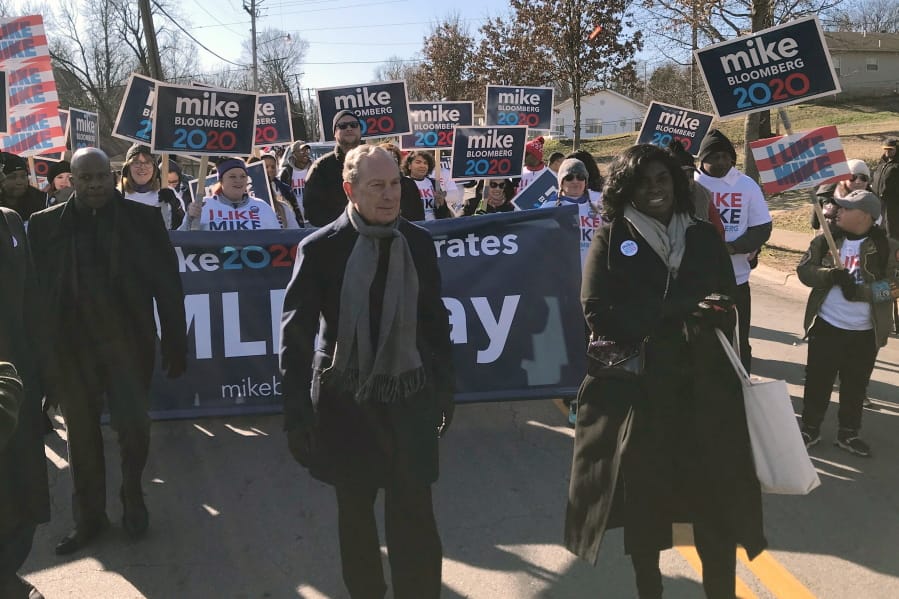 In this Jan. 20, 2020 photo, former New York City Mayor, and Democratic presidential candidate Michael Bloomberg walks with supporters along the route of the Little Rock &quot;marade&quot; marking the Martin Luther King Jr. holiday in Little Rock, Ark.