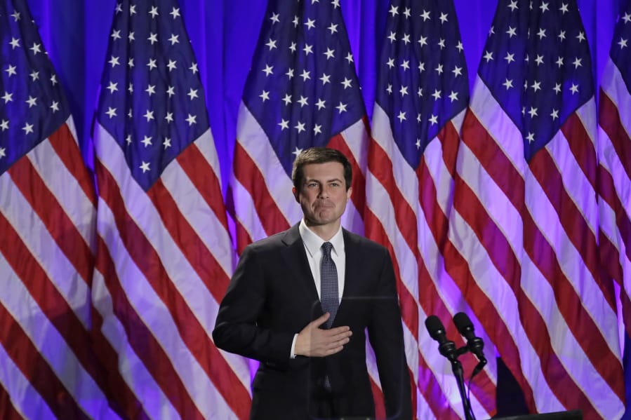 FILE - In this Nov. 11, 2019, file photo, Democratic presidential candidate South Bend, Ind. Mayor Pete Buttigieg reacts to applause after delivering a Veterans Day address during a campaign event in Rochester, N.H.  Buttigieg volunteered for military service and did a seven month tour in Afghanistan as an intelligence officer. He walks a narrow path between giving his wartime service its due and overstating it.