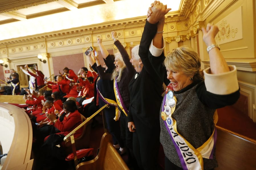 Equal Rights Amendment supporter Donna Granski, right, from Midlothian, Va., cheers the passage of the House ERA Resolution in the Senate chambers at the Capitol in Richmond, Va. Monday. The resolution passed 27-12.