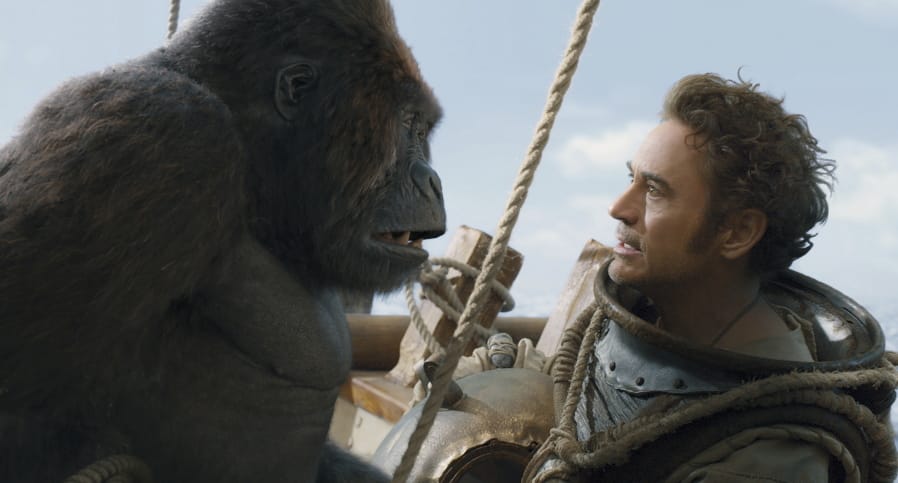 Chee-Chee, voiced by Rami Malek, left, and Dr. John Dolittle, portrayed by Robert Downey Jr.