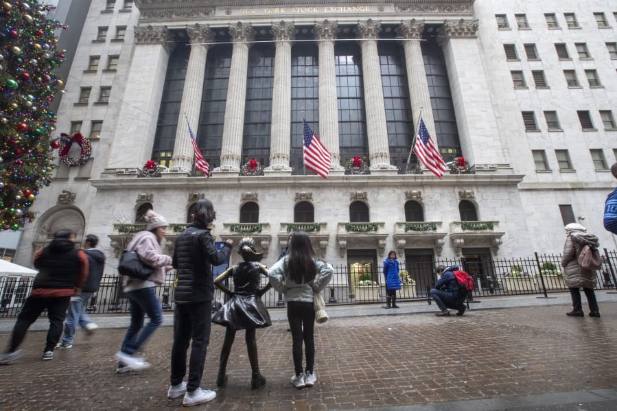 FILE - In this Jan. 3, 2020, file photo visitors to the New York Stock Exchange pause to take photos in New York. The U.S. stock market opens at 9:30 a.m. EST on Wednesday, Jan. 8.