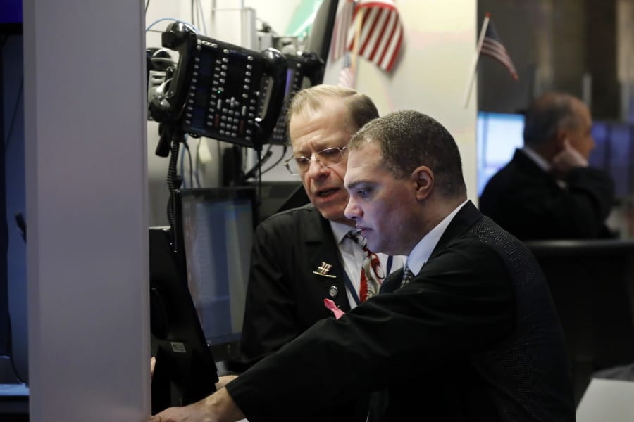 A pair of traders confer on the floor of the New York Stock Exchange, Thursday, Jan. 9, 2020. Stocks are opening broadly higher on Wall Street as traders welcome news that China&#039;s top trade official will head to Washington next week to sign a preliminary trade deal with the U.S.