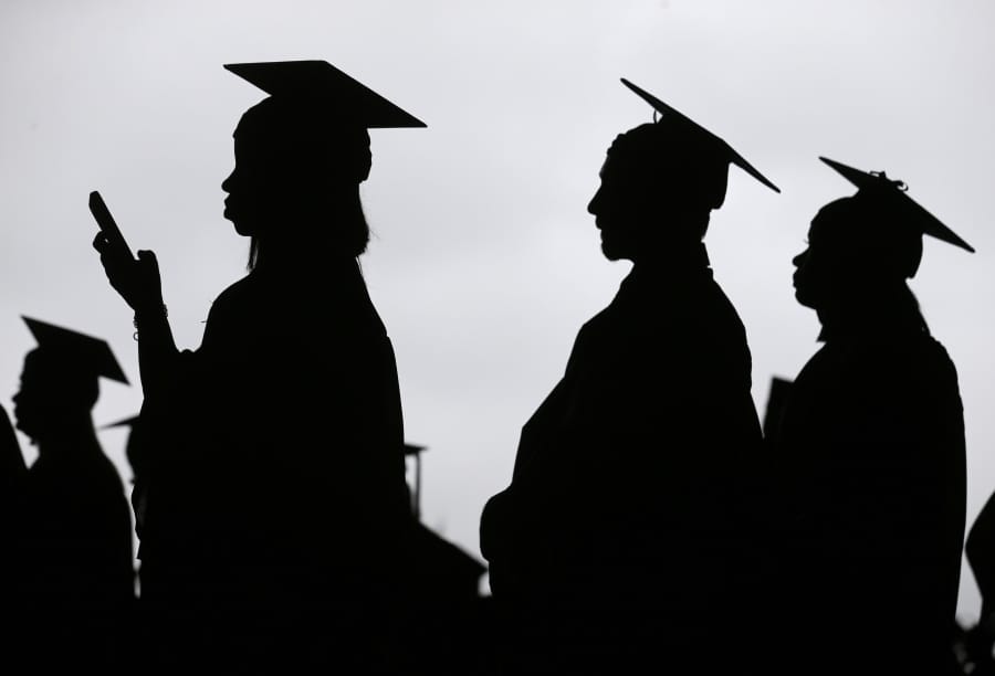 FILE - In this May 17, 2018, file photo, new graduates line up before the start of the Bergen Community College commencement at MetLife Stadium in East Rutherford, N.J. Americans who have spent time in foster care are far more likely than other adults to lack a college degree, health insurance and a stable health care provider, according to a new federal analysis released Wednesday, Jan. 22, 2020, that is unprecedented in its scope.