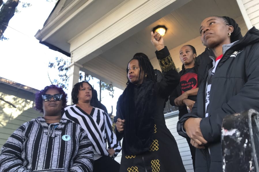 FILE - In this Dec. 30, 2019, file photo, Sharena Thomas, left, Carroll Fife, center, Dominique Walker, second from right, and Tolani KIng, right, stand outside a vacant home they took over on Magnolia Street in West Oakland, Calif. Homeless women ordered by a judge last week to leave a vacant house they occupied illegally in Oakland for two months have been evicted by sheriff&#039;s deputies. They removed two women and a male supporter Tuesday, Jan. 14, 2020, from the home before dawn in a case highlighting California&#039;s severe housing shortage and growing homeless population.