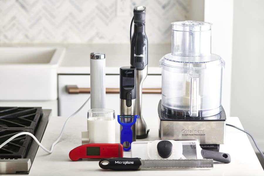 This December 2019 photo shows an assortment of various kitchen gadgets in New York, including a food processor, back right.