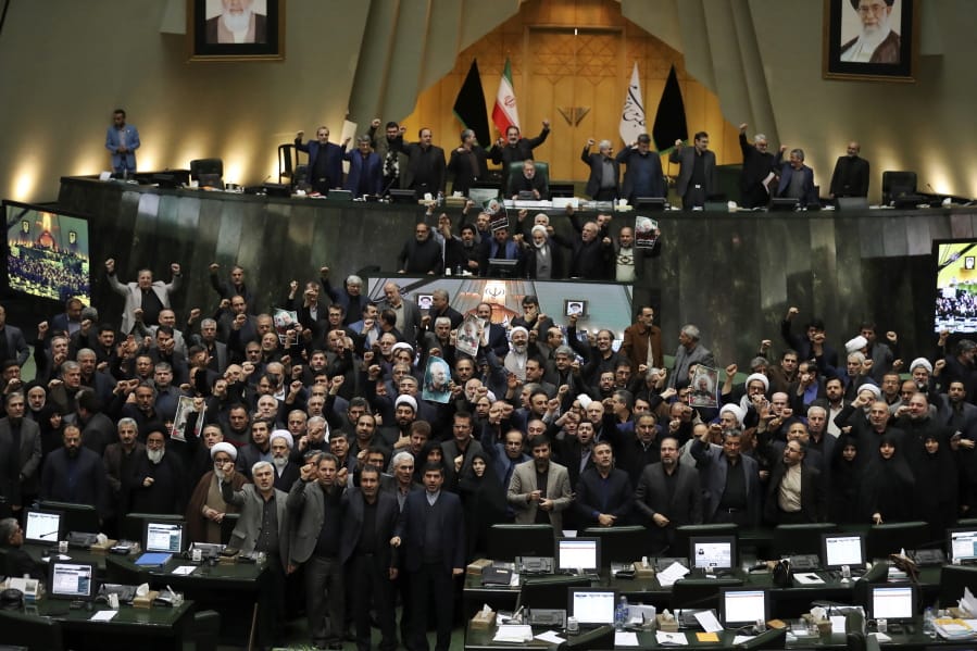 Iranian lawmakers chant slogans as some of them hold posters of Gen. Qassem Soleimani, who was killed in Iraq in a U.S. drone attack, in an open session of parliament, in Tehran, Iran, Tuesday, Jan. 7, 2020. Iran&#039;s parliament has passed an urgent bill declaring the U.S. military&#039;s command at the Pentagon in Washington and those acting on its behalf &quot;terrorists,&quot; subject to Iranian sanctions.