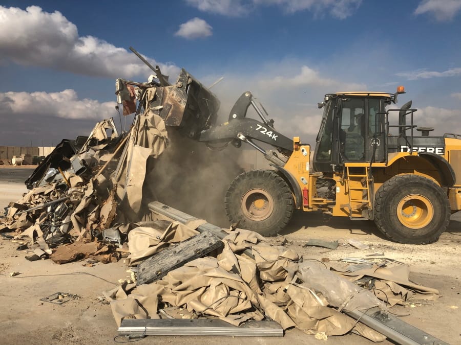 A bulldozer clears rubble and debris at Ain al-Asad air base Monday in Anbar province, Iraq. The base was struck by a barrage of Iranian missiles on Jan. 7.