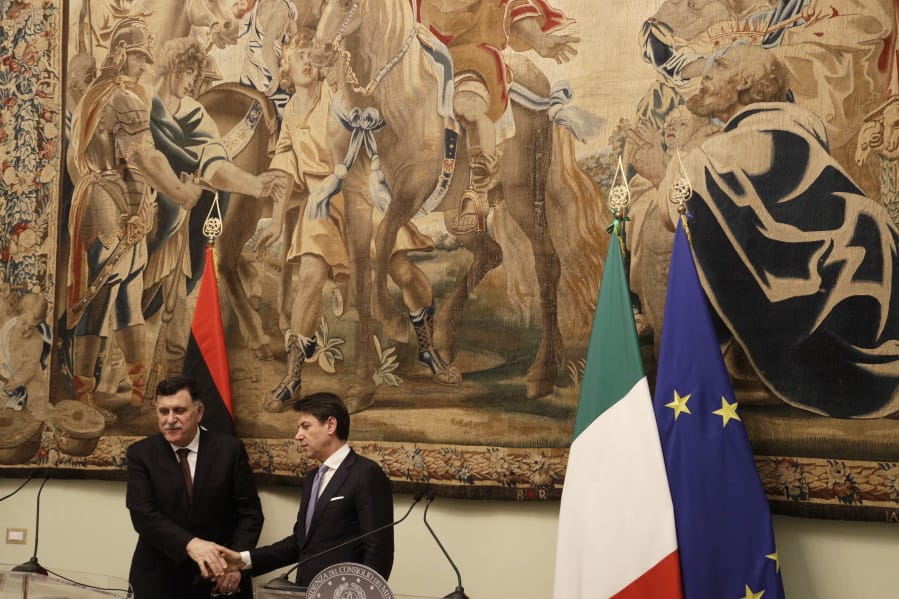 Libya&#039;s Prime Minister Fayez al-Sarraj, left, shakes hands with Italian Premier Giuseppe Conte after their meeting at Chigi palace, in Rome, Saturday, Jan. 11, 2020.