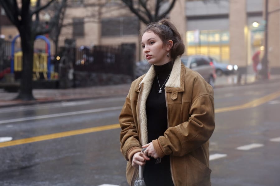 In this Dec. 30, 2019, photo, Shoshana Blum, a 20-year-old junior at City College of New York, waits for a taxi in New York. Despite having been victim to a verbal and physical anti-Semitic attack on the subway, Blum wears her Star of David pendant, a visible marker of her Jewish identity, proudly.