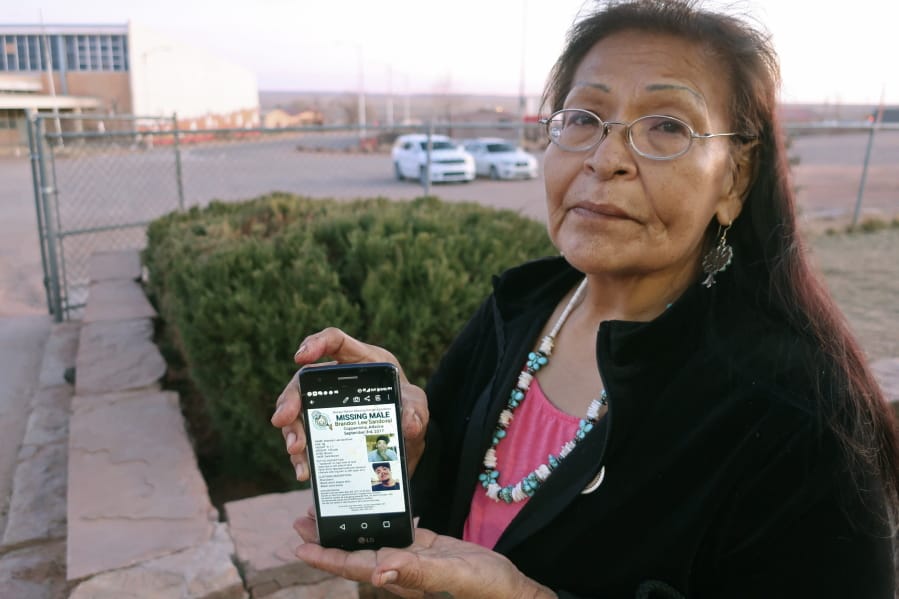 In this Jan. 14, 2020, photo, Margaret Bitsue displays a flier that features her son who she reported missing more than two years ago, Tuba City, Ariz. Bitsue hasn&#039;t seen or heard from Brandon Sandoval, the youngest of her four children, in more than two years. &quot;I spend most of my days looking down the road expecting him to come up,&quot; Bitsue says. The woman&#039;s words are soft but capture a room at a Navajo Nation government center, where people are gathered to talk not about women and girls who have disappeared or been killed, but men.