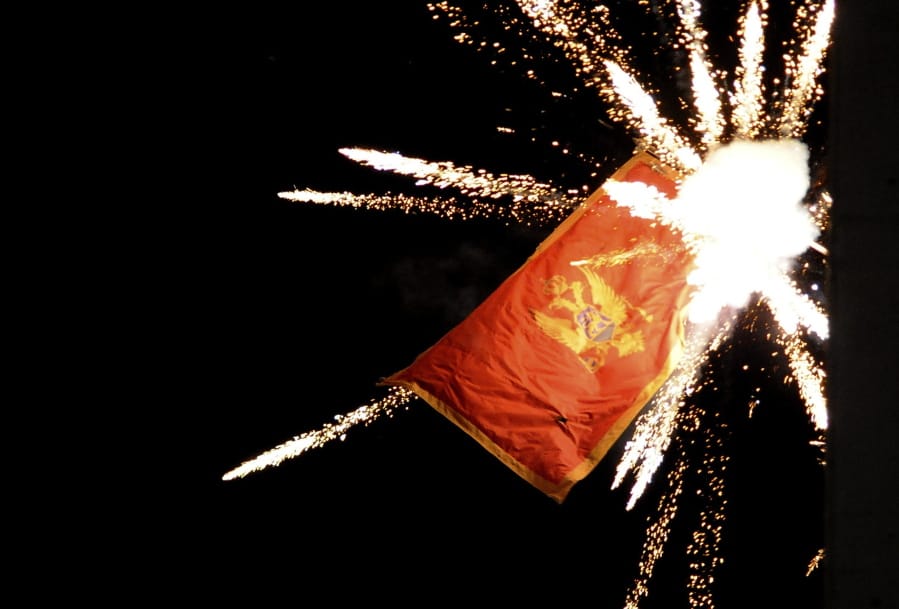 The Montenegrin flag flying from the Montenegrin Embassy, is targeted with fireworks by Serbian ultra-nationalists during a protest against a religion rights law adopted by Montenegro&#039;s parliament last month, during a mass protest in Belgrade, Serbia, Thursday, Jan. 2, 2020.  Montenegro on Friday strongly denounced aggression against its embassy in Serbia during a protest by some thousands of ultra-nationalists, saying the action represented an attack on the country&#039;s independence.