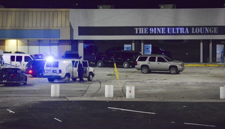 Kansas City, Mo., police crime scene investigators gather evidence at the scene of a shooting at a nightclub in the early hours of Monday, Jan. 20, 2020, in Kansas City, Mo.