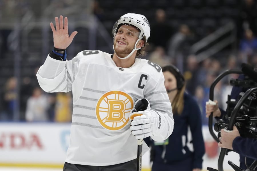 Boston Bruins forward David Pastrnak waves to the crowd as he is named the most valuable player of the NHL hockey All Star games Saturday, Jan. 25, 2020, in St. Louis.