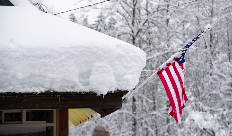 Snow covers the roof of Steven&#039;s Pizza in Skykomish, Wash., along Highway 2, Wednesday, Jan. 15, 2020, in Skykomish, Wash. Volunteers brought food and supplies here for local Skykomish residents stranded without power or access to food.