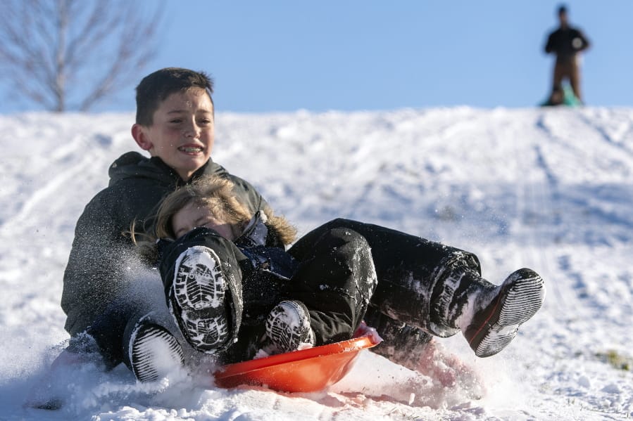 Luke Stanton, 12, and his sister, Hannah, 6, both of Lewiston, Idaho, sled hill at Sunset Park on Friday, Jan. 17, 2020, in Lewiston, Idaho.