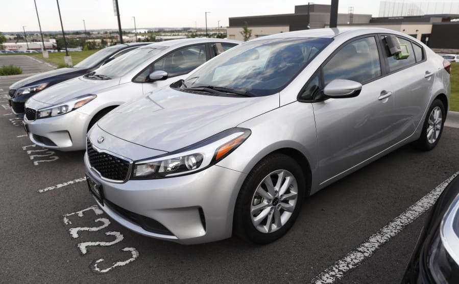 A used 2017 Kia Forte sits in a row of other used, late-model sedans at a dealership in Centennial, Colo.