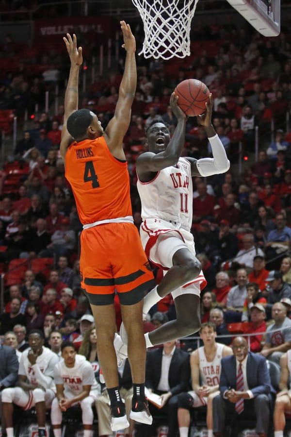 Utah guard Both Gach (11) goes to the basket as Oregon State forward Alfred Hollins (4) defends in the second half during an NCAA college basketball game Thursday, Jan. 2, 2020, in Salt Lake City.