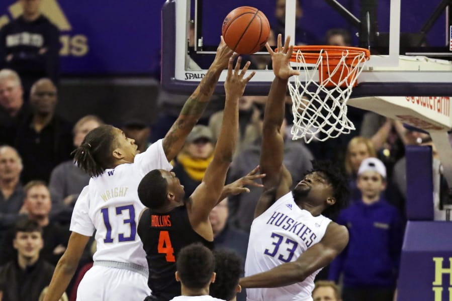 Oregon State forward Alfred Hollins (4) has a shot blocked by Washington forward Isaiah Stewart (33) and forward Hameir Wright (13) during the first half of an NCAA college basketball game Thursday, Jan. 16, 2020, in Seattle. (AP Photo/Ted S.