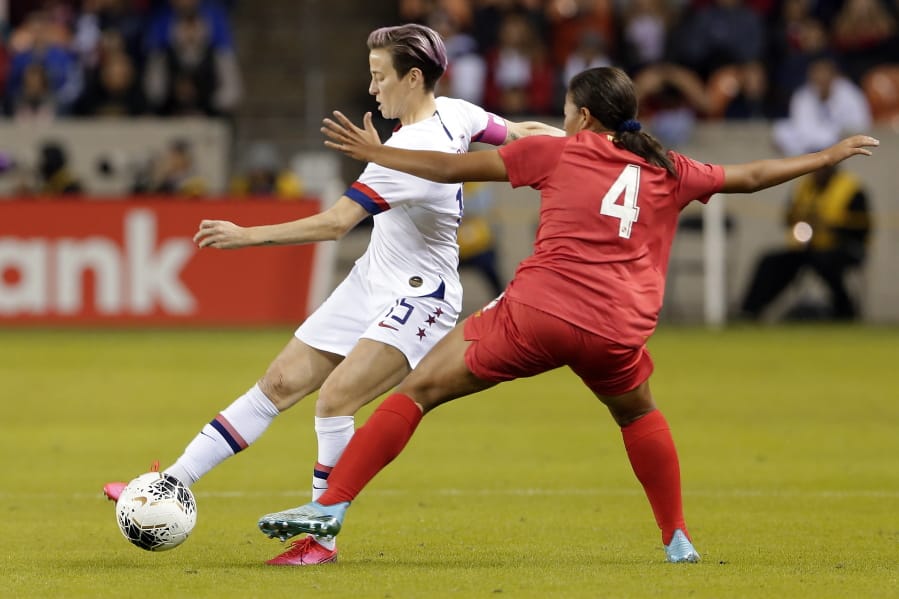 U.S. forward Megan Rapinoe (15) moves the ball under pressure from Panama defender Hilary Jaen (4) during the first half of a CONCACAF women&#039;s Olympic qualifying soccer match Friday, Jan. 31, 2020, in Houston.
