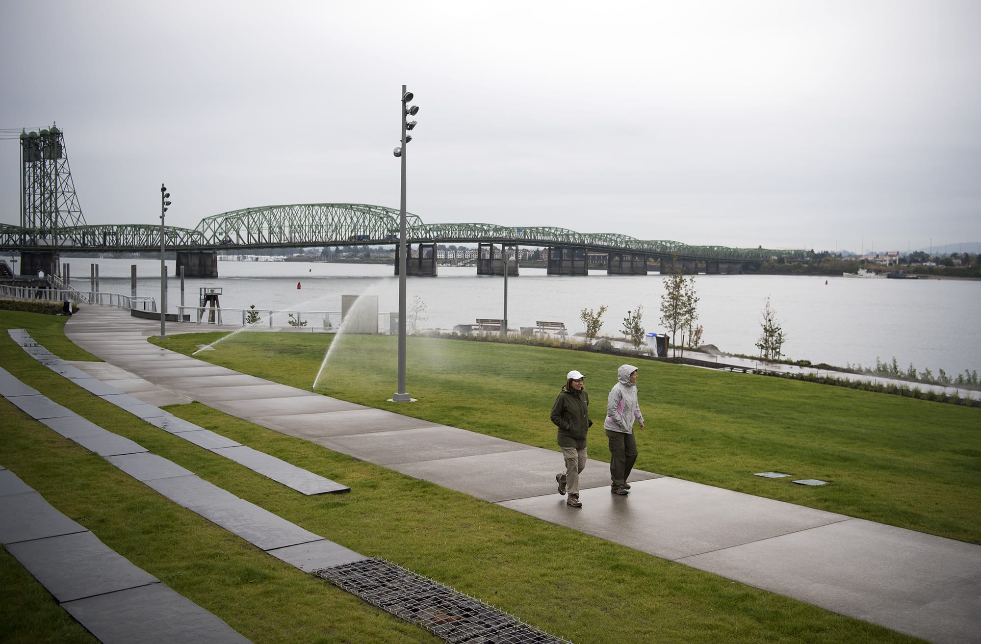 Kim Pohlman of Vancouver, left, Karen Conway of Cincinnati, Ohio, right, and walk along the Vancouver Waterfront Park on Friday afternoon, Oct. 5, 2018. Conway use to live in Vancouver and is back for a visit so the friends decided to brave the rain to check it out. "We were smiling because rain doesn't stop us," Pohlman said.