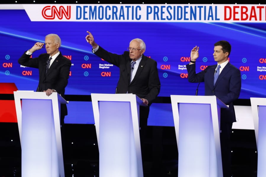 FILE - In this Tuesday, Jan. 14, 2020 file photo, from left, Democratic presidential candidate former Vice President Joe Biden, Sen. Bernie Sanders, I-Vt.,and former South Bend Mayor Pete Buttigieg look to answer a question during a Democratic presidential primary debate hosted by CNN and the Des Moines Register in Des Moines, Iowa. Multiple Democratic presidential hopefuls have talked about their faith on the campaign trail, weaving it into their approach to issues from immigration to climate change. Among the most vocal Democrats on that front is Buttigieg, who asserted his party&#039;s connection to religion on Tuesday during its final primary debate before next month&#039;s first-in-the-nation Iowa caucus.