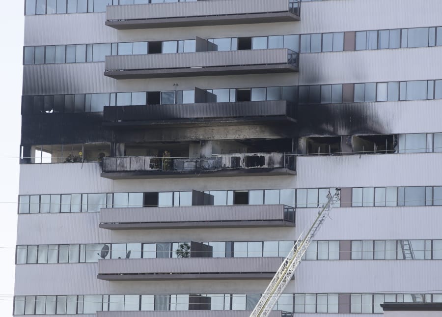 Fire and smoke damage is seen on the exterior of a residential building in Los Angeles, Wednesday, Jan. 29, 2020. Los Angeles firefighters rescued terrified residents from the rooftop of a 25-story high-rise apartment building where a fire broke out on a sixth-floor balcony and sent choking smoke billowing through the upper levels.