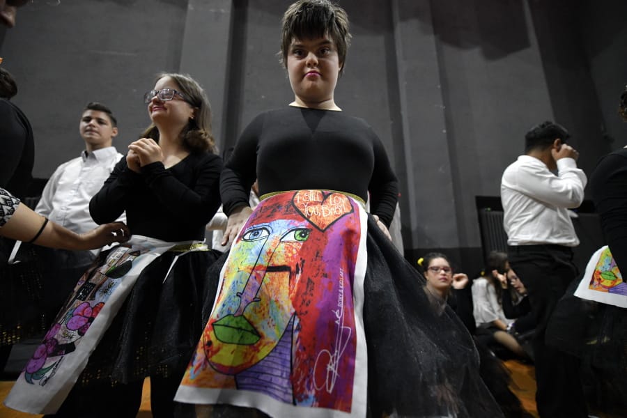 In this Nov. 3, 2019, photograph a child with Down syndrome prepare to show skirts displaying drawings inspired by children, during a fashion show dubbed &quot;heART Couture&quot; in Bucharest, Romania.