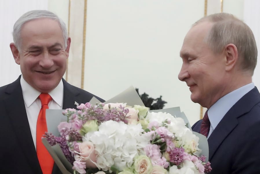 Russian President Vladimir Putin, right, prepares to greet Israeli Prime Minister Benjamin Netanyahu&#039;s wife Sara prior to talks with Israeli Prime Minister Benjamin Netanyahu in the Kremlin in Moscow, Russia, Thursday, Jan. 30, 2020. Netanyahu visited Moscow to discuss the U.S. Mideast peace plan with Putin and take an Israeli woman who had been jailed in Russia back home.