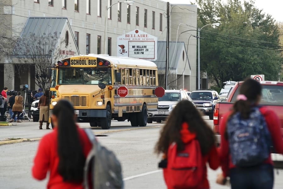 Students watch from across the street as authorities respond to a shooting at Bellaire High School in Bellaire, Texas, Tuesday, Jan. 14, 2020.