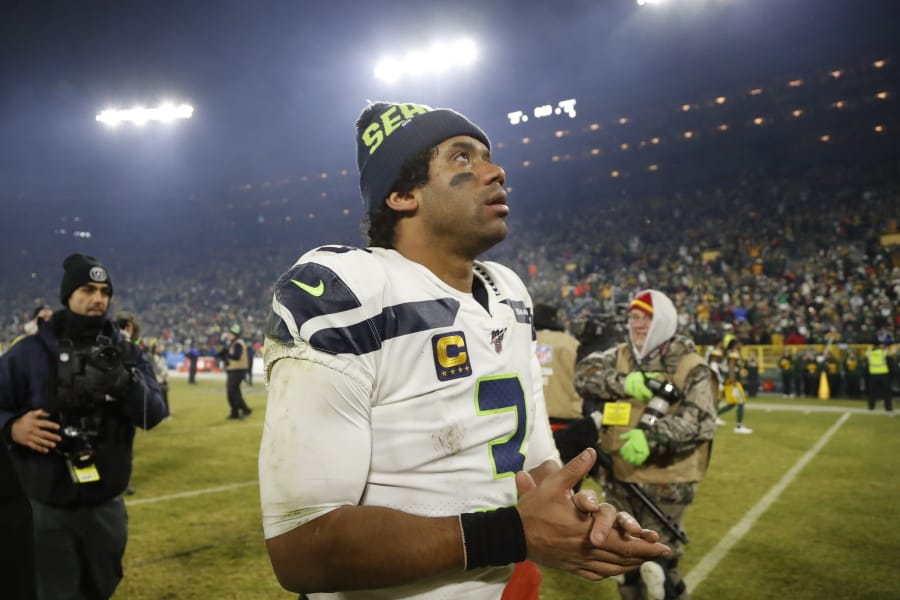 Seattle Seahawks&#039; Russell Wilson walks off the field after a 28-23 loss to the Green Bay Packers in the NFL divisional playoffs on Sunday.