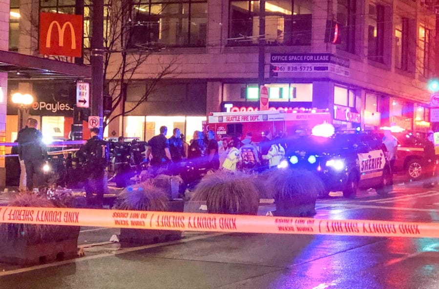 Police work the scene of a shooting on Third Avenue and Pine Street, Wednesday, Jan. 22, 2020, in Seattle.