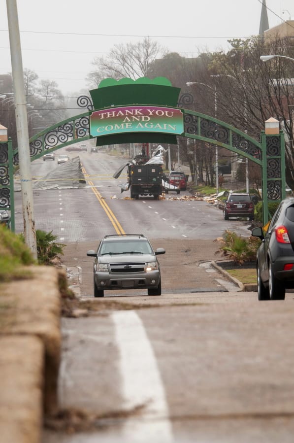 City of Greenville, Miss., trucks and employees, work to clean up debris from a storm along Main Street, Saturday, Jan. 11, 2020, in Greenville, Miss. Severe storms swept across parts of the U.S. South and were blamed for deaths, destruction and damages.