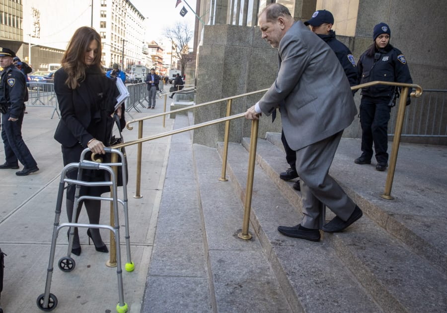 Harvey Weinstein&#039;s lead attorney Donna Rotunno, left, holds his walker at the bottom of a staircase as he leaves court for the day during jury selection in his trial on rape and sexual assault charges, Wednesday, Jan. 15, 2020, in New York. Jury selection continues Thursday.