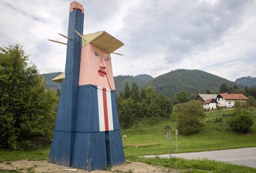 FILE - In this file photo dated Friday, Aug. 30, 2019, a wooden statue resembling Donald Trump near Kamnik, Slovenia.  The wooden statue nearly eight-meter high (26 feet) of U.S. President Donald Trump that was constructed in 2019, has been destroyed by fire Thursday Jan. 9, 2020, in the homeland of his wife Melania Trump.