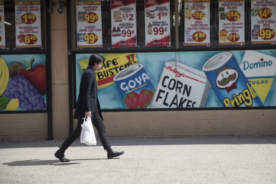 FILE - In this March 27, 2019, file photo a man leaves a supermarket in the East Village neighborhood of Manhattan carrying his groceries in a plastic bag. A growing number of states, counties and cities have passed legislation prohibiting or restricting retailers and other businesses from giving customers single-use plastic bags to carry purchases. Oregon&#039;s ban went into effect Jan. 1, 2020 and Maine, New York state and Vermont have similar prohibitions going into effect later in the year.